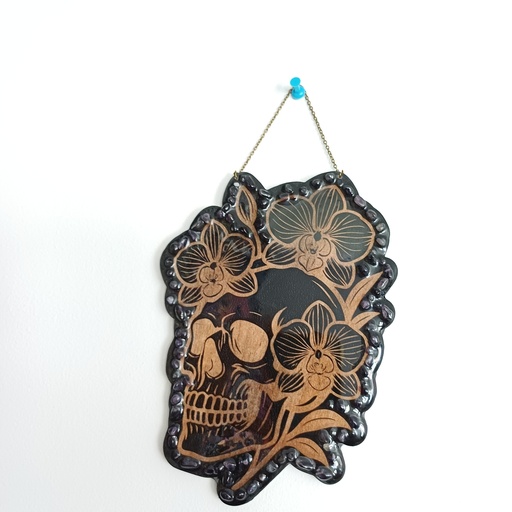 Wooden skull and orchid decoration with natural stones
